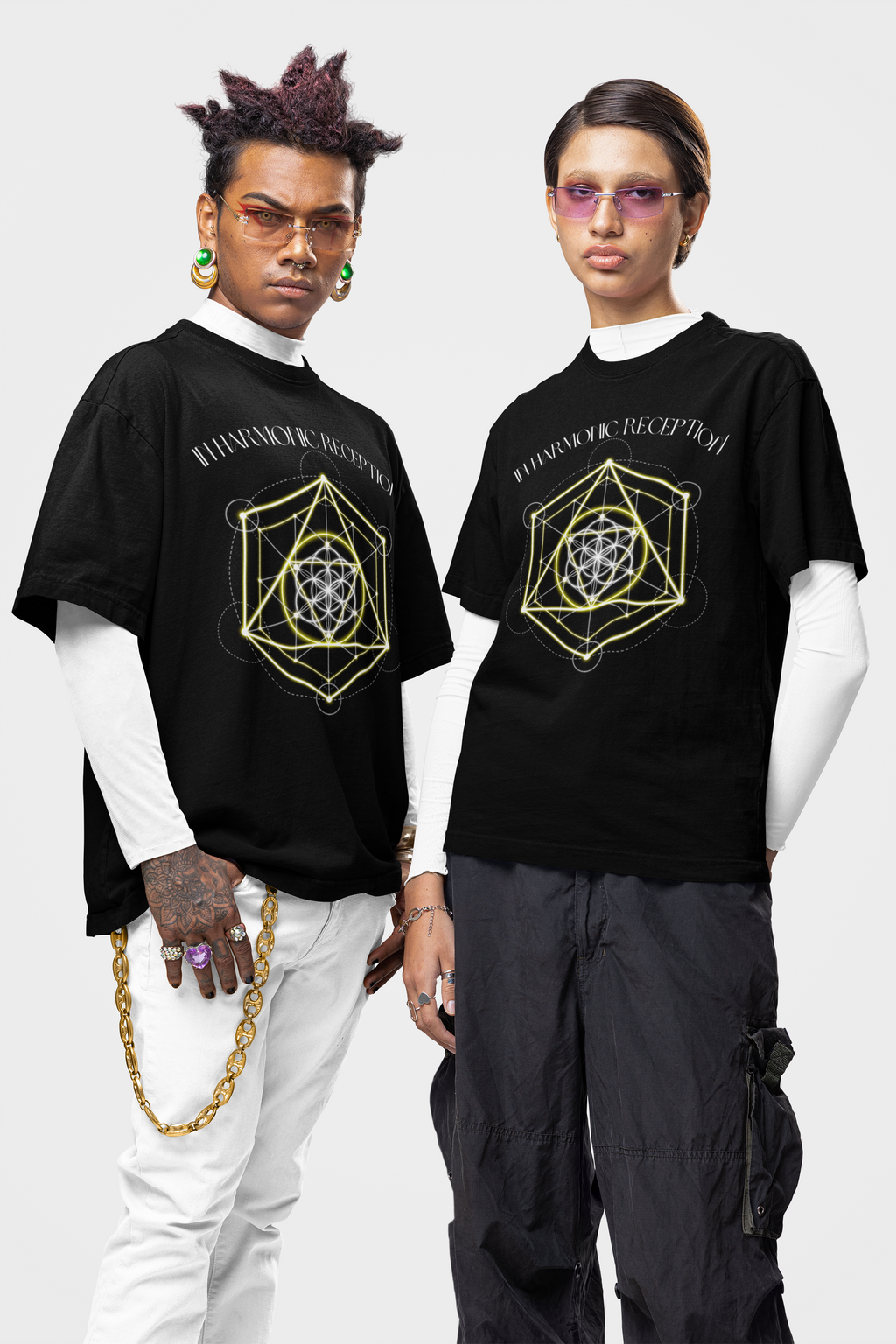 Two people wearing black t-shirts with geometric designs on a white background