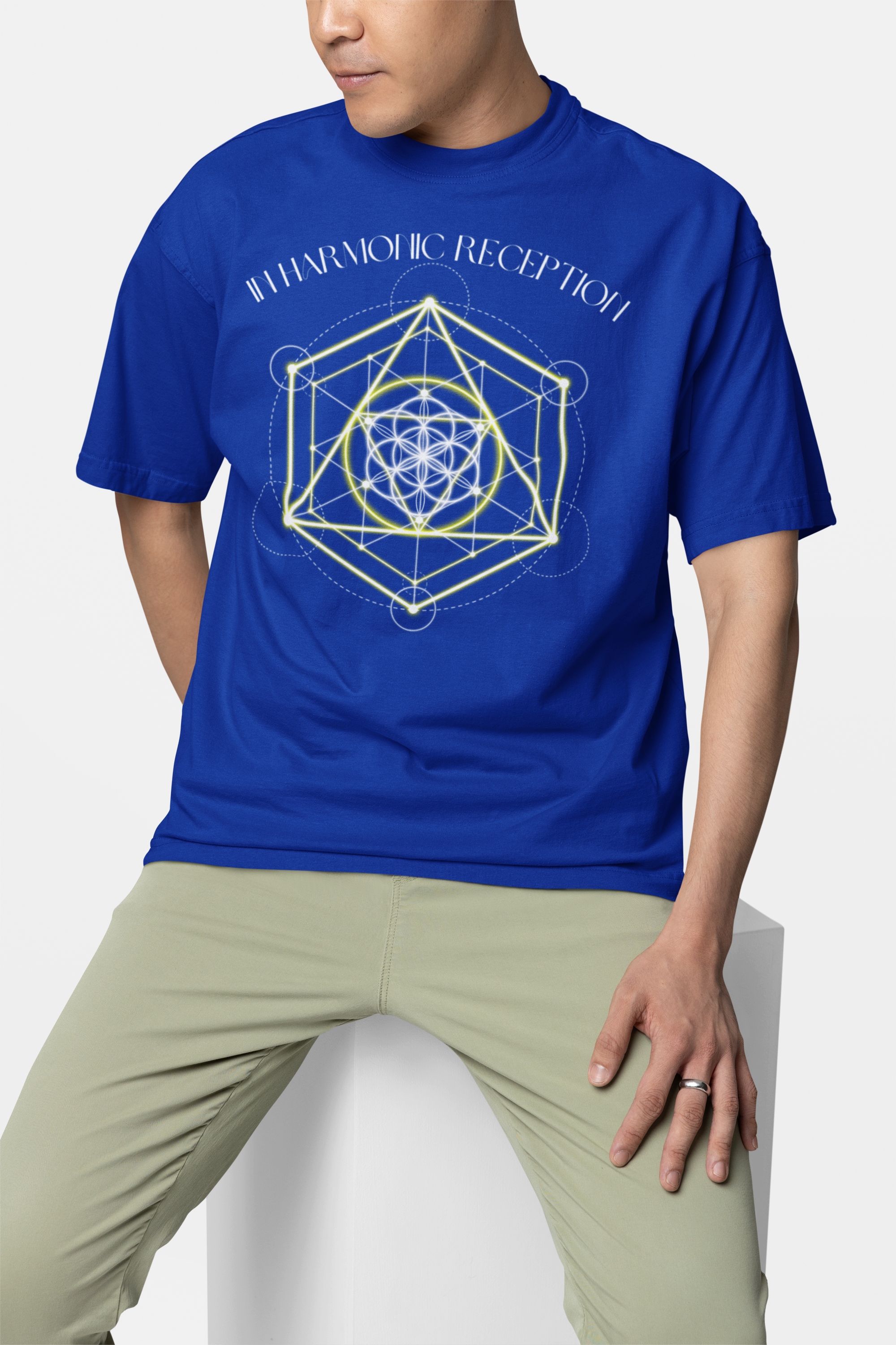 Person wearing a blue t-shirt with a geometric design and text on a white background