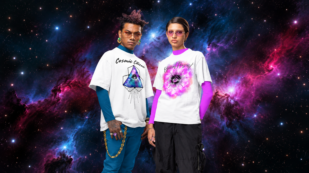 Two models standing against a vibrant cosmic nebula background, wearing white graphic t-shirts. The model on the left wears a white t-shirt with a black 'Cosmic Citizen' triangle logo, layered over a blue long-sleeve shirt and blue pants.