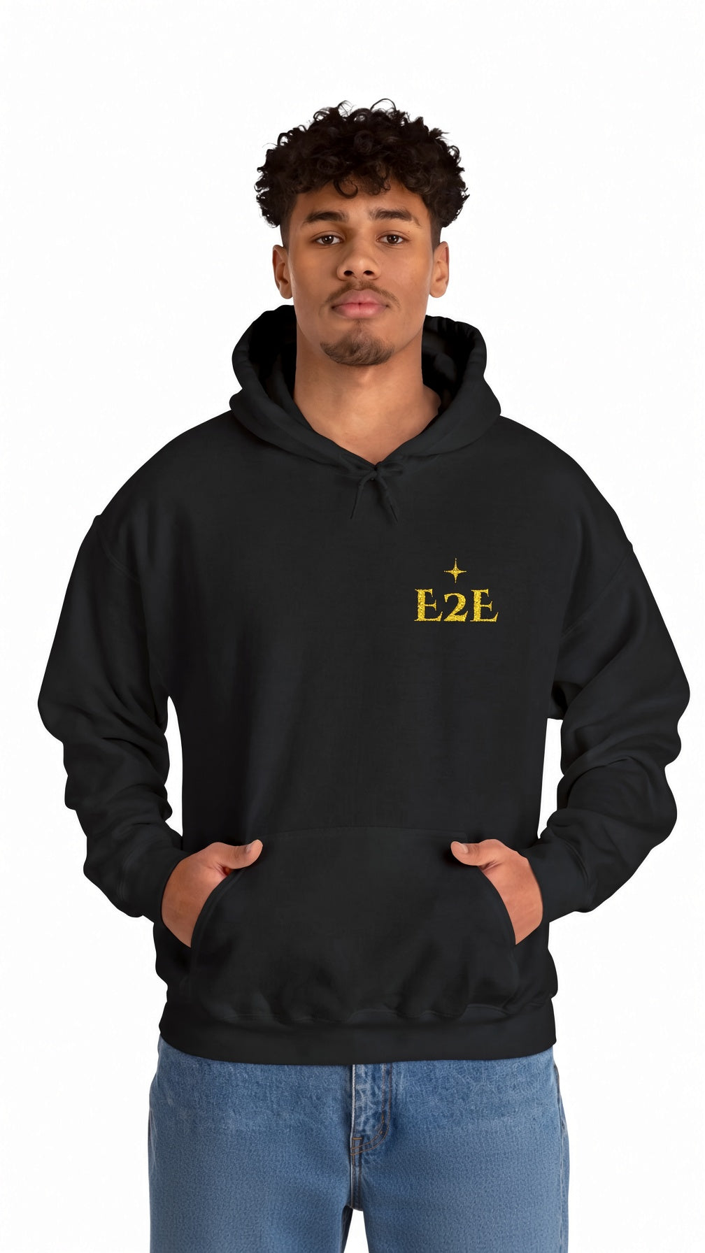 A man wearing a black pullover hoodie with a small yellow 'E2E' graphic on the left chest, paired with blue jeans, against a plain white background.