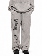 Model wearing Timeline Jumper light gray snow wash sweatpants with black artwork on the right leg