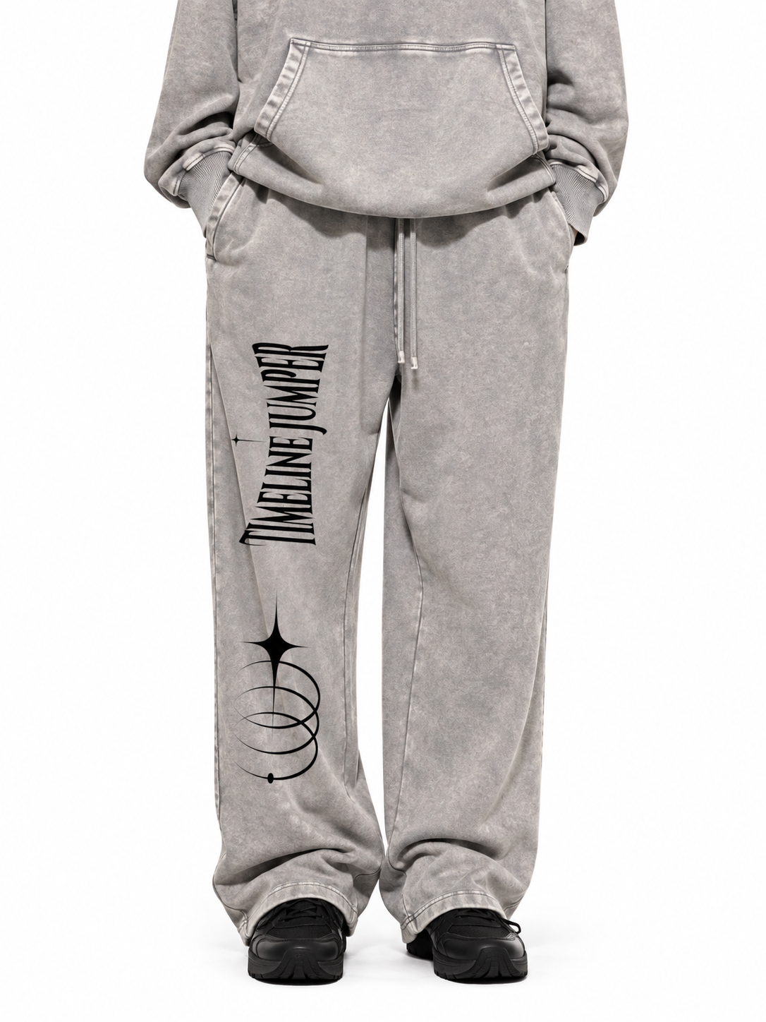 Model wearing Timeline Jumper light gray snow wash sweatpants with black artwork on the right leg