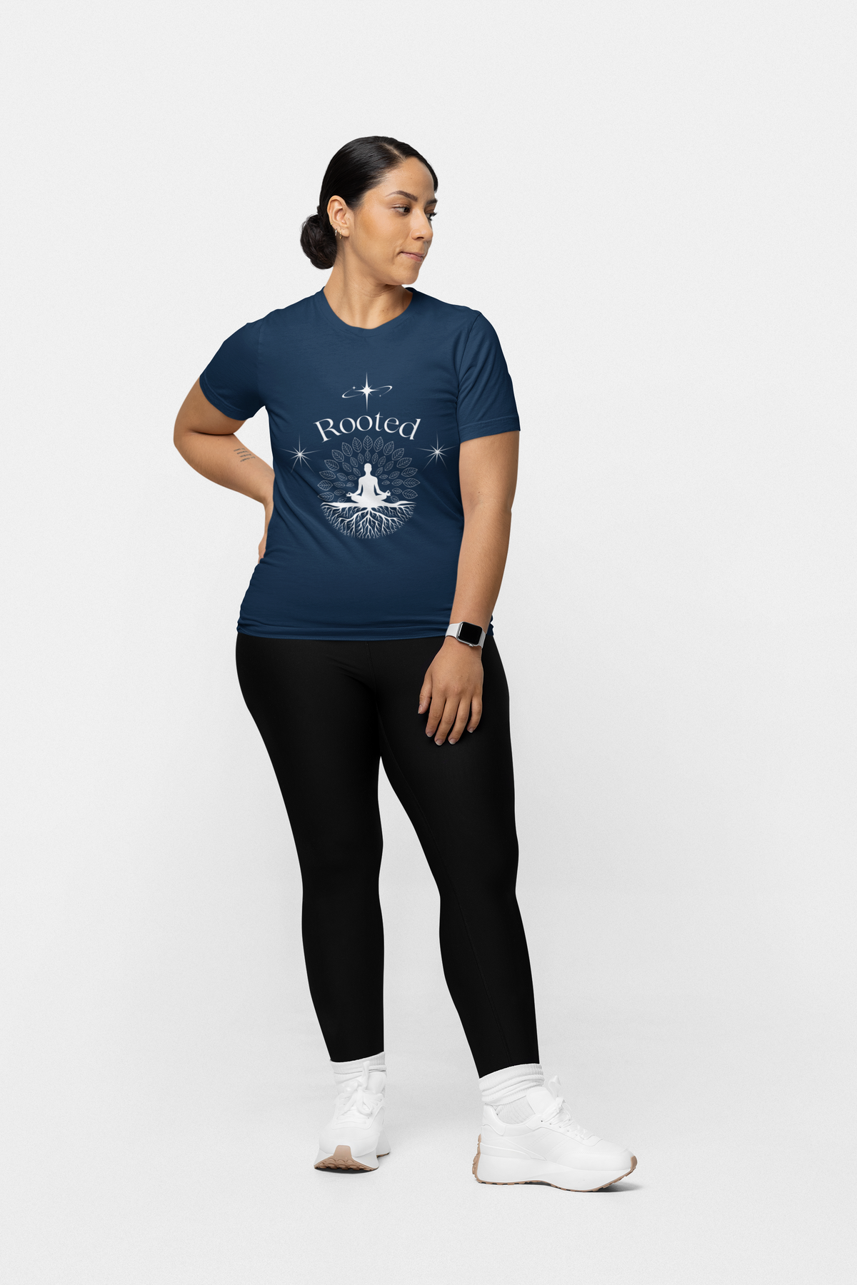 Person wearing a navy blue t-shirt with 'Rooted' design on a white background